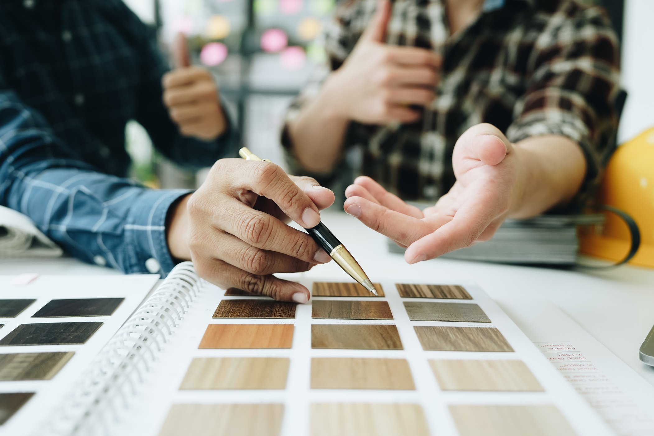 Engineers, designers and interior designers are finalizing the design of interiors by discussing selecting materials and colors to design rooms to present to clients.